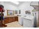 Bright laundry room with cabinets and built in storage at 424 E Lehi Rd, Mesa, AZ 85203