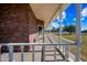 Side porch with white railings, brick exterior, and spacious view at 424 E Lehi Rd, Mesa, AZ 85203