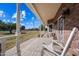 Porch with rocking chairs, offering a view of the yard and surrounding area at 424 E Lehi Rd, Mesa, AZ 85203