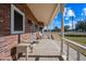 Porch with rocking chair and side table overlooking the yard at 424 E Lehi Rd, Mesa, AZ 85203