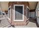 Brick home's side porch features a large window and white railings at 424 E Lehi Rd, Mesa, AZ 85203