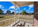 Porch view of a grassy yard, trees, and a glimpse of the street at 424 E Lehi Rd, Mesa, AZ 85203