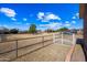 White metal gate and fence enclosing a large grassy area at 424 E Lehi Rd, Mesa, AZ 85203