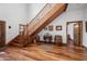 Grand wooden staircase with ornate banister and hardwood floors at 424 E Lehi Rd, Mesa, AZ 85203