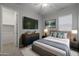 Modern bedroom with large TV, dresser and closet at 4267 E Bernice St, Gilbert, AZ 85295