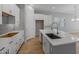 Modern kitchen with white cabinets, an island, and stainless steel sink at 4267 E Bernice St, Gilbert, AZ 85295