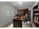 Home office with built-in shelving and a large desk at 4267 E Bernice St, Gilbert, AZ 85295