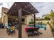 Relaxing backyard oasis with a sparkling pool, pergola, and patio furniture at 4362 E Clifton Ave, Gilbert, AZ 85295