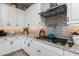 Modern kitchen features white cabinets and gray tile backsplash at 4362 E Clifton Ave, Gilbert, AZ 85295