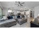 Open concept living room with gray sectional sofa and adjacent kitchen at 4362 E Clifton Ave, Gilbert, AZ 85295