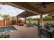 Covered patio with comfortable seating, string lights, and pool access at 4362 E Clifton Ave, Gilbert, AZ 85295