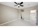 Well-lit bedroom with ceiling fan and closet at 44478 W Palo Abeto Dr, Maricopa, AZ 85138