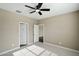 Bedroom with ceiling fan and access to bathroom at 44478 W Palo Abeto Dr, Maricopa, AZ 85138