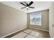 Bedroom with ceiling fan and large window at 44478 W Palo Abeto Dr, Maricopa, AZ 85138