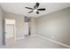 Spacious bedroom with ceiling fan and carpet at 44478 W Palo Abeto Dr, Maricopa, AZ 85138