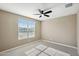 Bright bedroom with large window and ceiling fan at 44478 W Palo Abeto Dr, Maricopa, AZ 85138