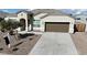 House exterior featuring a brown garage door and a landscaped front yard at 44478 W Palo Abeto Dr, Maricopa, AZ 85138