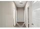 Bright hallway with wood-look tile flooring at 44478 W Palo Abeto Dr, Maricopa, AZ 85138