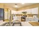 Open kitchen with white cabinets, breakfast bar, and tile floors at 4711 E Silverwood Dr, Phoenix, AZ 85048