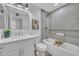 Modern bathroom with white vanity, bathtub, and gray tile at 4901 E Sheridan St, Phoenix, AZ 85008