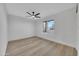 Bright bedroom featuring light wood flooring and a ceiling fan at 4901 E Sheridan St, Phoenix, AZ 85008