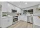 Renovated kitchen with white cabinets, quartz countertops, and stainless steel appliances at 4901 E Sheridan St, Phoenix, AZ 85008