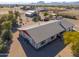 Aerial view of a ranch home with a large yard and outbuildings at 52615 W Esch Trl, Maricopa, AZ 85139