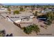 Aerial view of a home with a large backyard, covered patio, hot tub, and wood pizza oven at 52615 W Esch Trl, Maricopa, AZ 85139