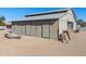 Large metal barn with multiple stalls and exterior space at 52615 W Esch Trl, Maricopa, AZ 85139