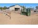 Tan metal barn with multiple stalls and large doors at 52615 W Esch Trl, Maricopa, AZ 85139