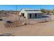 Aerial view of barn with multiple stalls and surrounding pens at 52615 W Esch Trl, Maricopa, AZ 85139