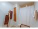 Simple bathroom with a shower and wooden towel rack at 52615 W Esch Trl, Maricopa, AZ 85139