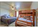 Bedroom with king-size bed and a wooden bunk bed at 52615 W Esch Trl, Maricopa, AZ 85139