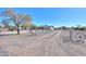 Gravel driveway leading to a charming ranch home at 52615 W Esch Trl, Maricopa, AZ 85139