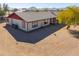 Ranch-style home with red accents and a large yard at 52615 W Esch Trl, Maricopa, AZ 85139