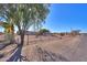 Single story home with a chain link fence and desert landscape at 52615 W Esch Trl, Maricopa, AZ 85139