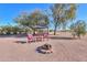 Relaxing fire pit with seating area in backyard at 52615 W Esch Trl, Maricopa, AZ 85139