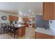 Kitchen with island, wood cabinets, and stainless steel appliances at 52615 W Esch Trl, Maricopa, AZ 85139