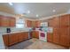 View of kitchen with wood cabinets and appliances at 52615 W Esch Trl, Maricopa, AZ 85139