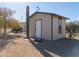 Tan storage shed with red trim and weathervane at 52615 W Esch Trl, Maricopa, AZ 85139