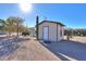 Detached storage shed with a door and window at 52615 W Esch Trl, Maricopa, AZ 85139