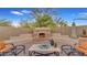 Stone fireplace and seating area in backyard at 5424 N 186Th Dr, Litchfield Park, AZ 85340