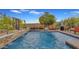 Inviting backyard pool with a stone waterfall feature and comfortable lounge seating at 5424 N 186Th Dr, Litchfield Park, AZ 85340