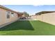 Artificial turf backyard with covered patio and block wall at 5758 W Kowalsky Ln, Laveen, AZ 85339