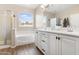 Bathroom with double vanity, soaking tub, and walk-in shower at 5758 W Kowalsky Ln, Laveen, AZ 85339