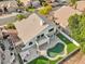 Aerial view showcasing a two-story house, pool, and surrounding landscape at 6270 W Rose Garden Ln, Glendale, AZ 85308