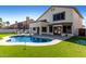 Relaxing backyard with a refreshing swimming pool, manicured lawn, and covered outdoor space at 6270 W Rose Garden Ln, Glendale, AZ 85308