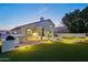 Expansive backyard with a pool, artificial turf, and outdoor kitchen at 6270 W Rose Garden Ln, Glendale, AZ 85308