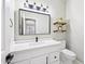 Modern bathroom with white vanity, floating shelves, and black fixtures at 6270 W Rose Garden Ln, Glendale, AZ 85308