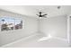 Simple bedroom with white walls, tile floors and a window at 6270 W Rose Garden Ln, Glendale, AZ 85308